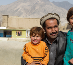 Photo of a scene showing a man with two young children in Afghanistan.