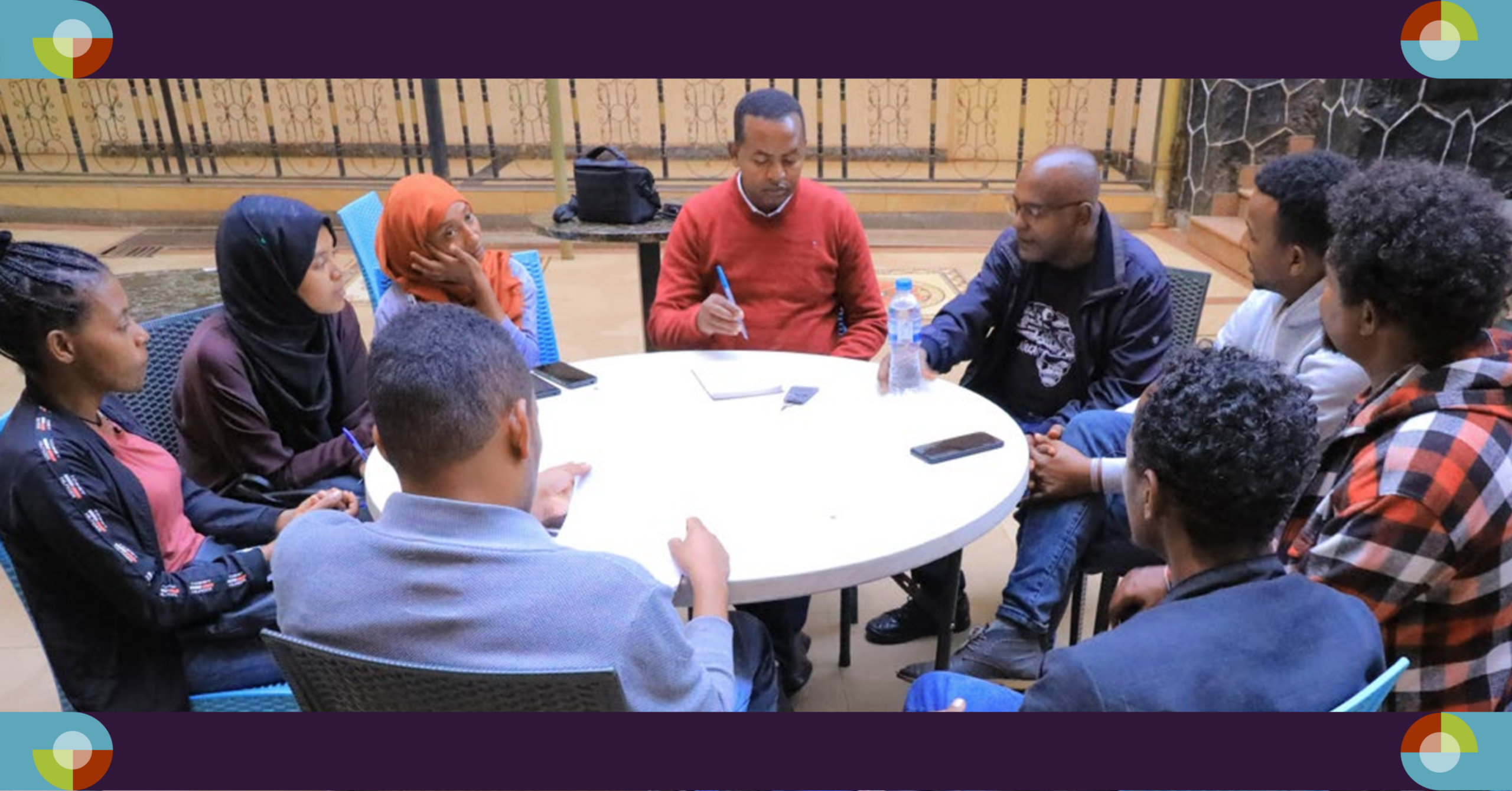 Photo showing a group of Ethiopian data collectors sitting around a table.