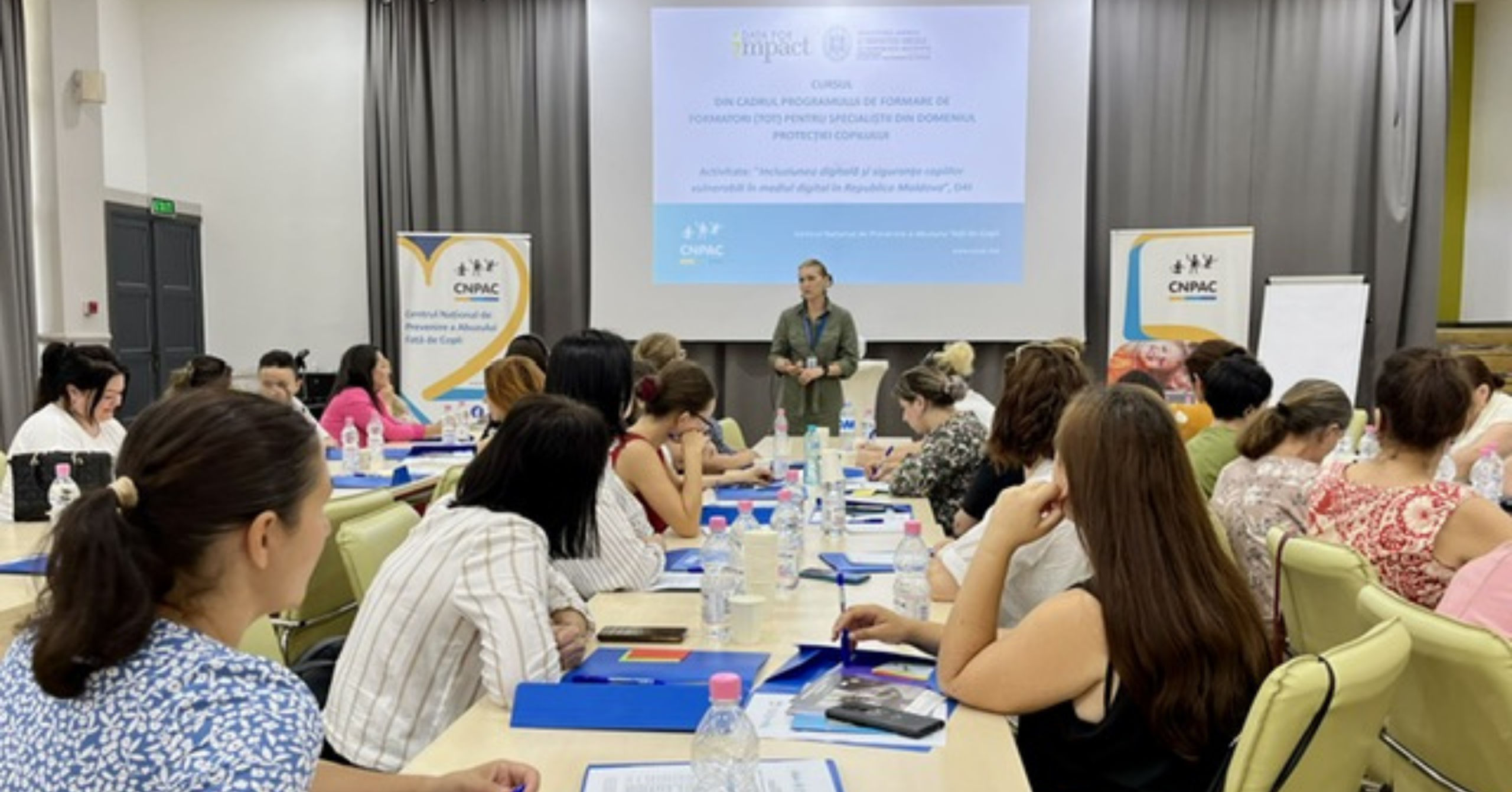 Photo showing a presenter and participants at the training course "Digital inclusion and Safety of Vulnerable Children in the Digital Environment in the Republic of Moldova."